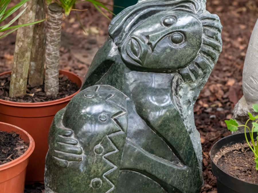 A stone statue among pots